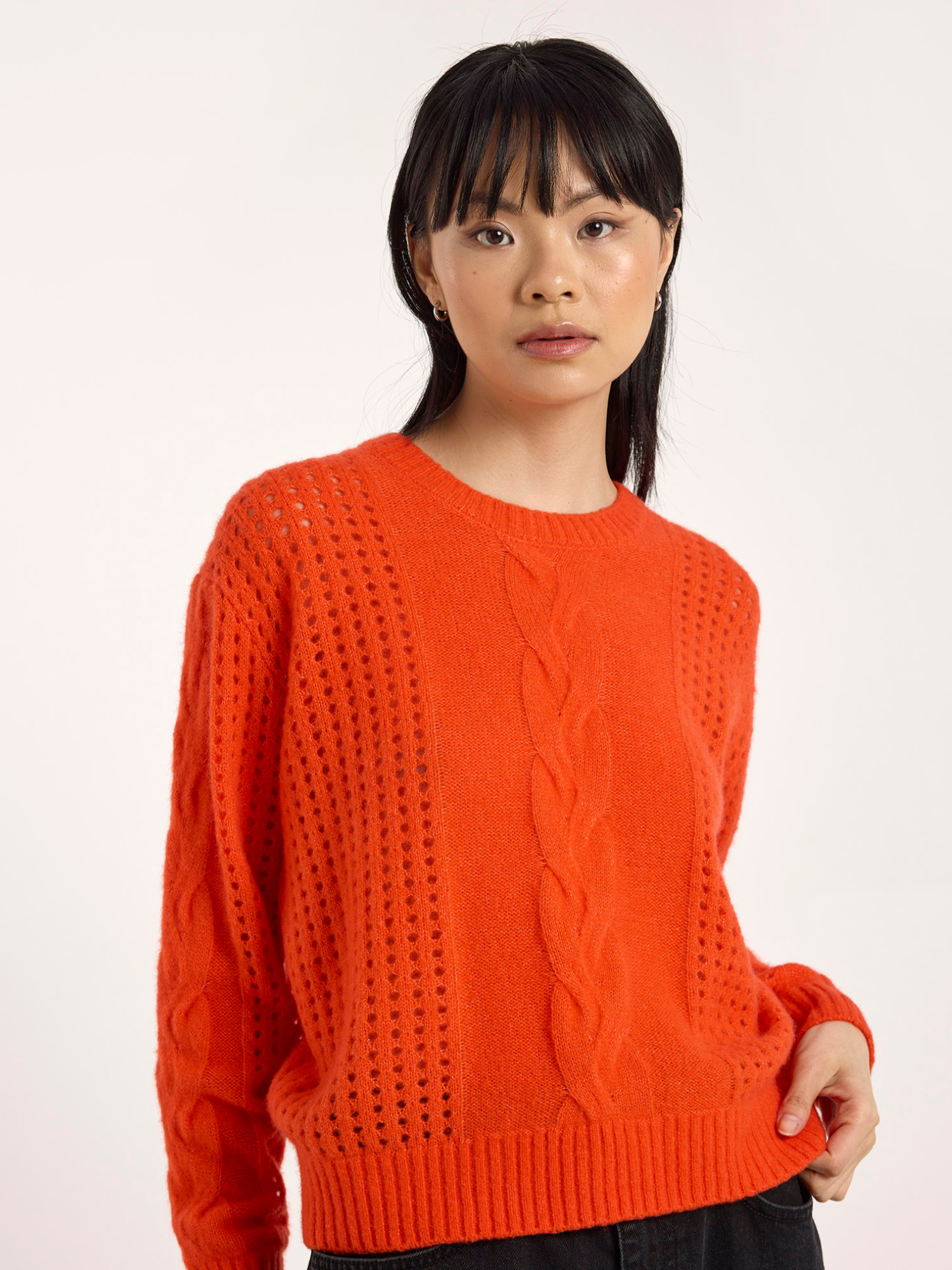 Woman wearing an orange cashmere jumper