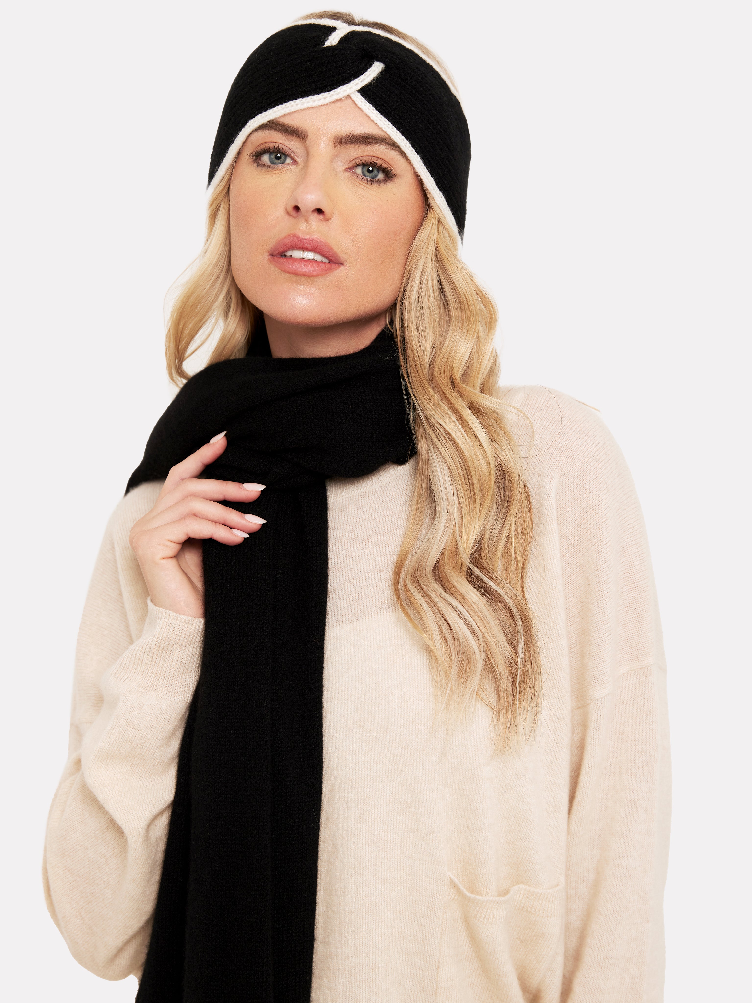 women wearing a black headband with white tipping and a black scarf