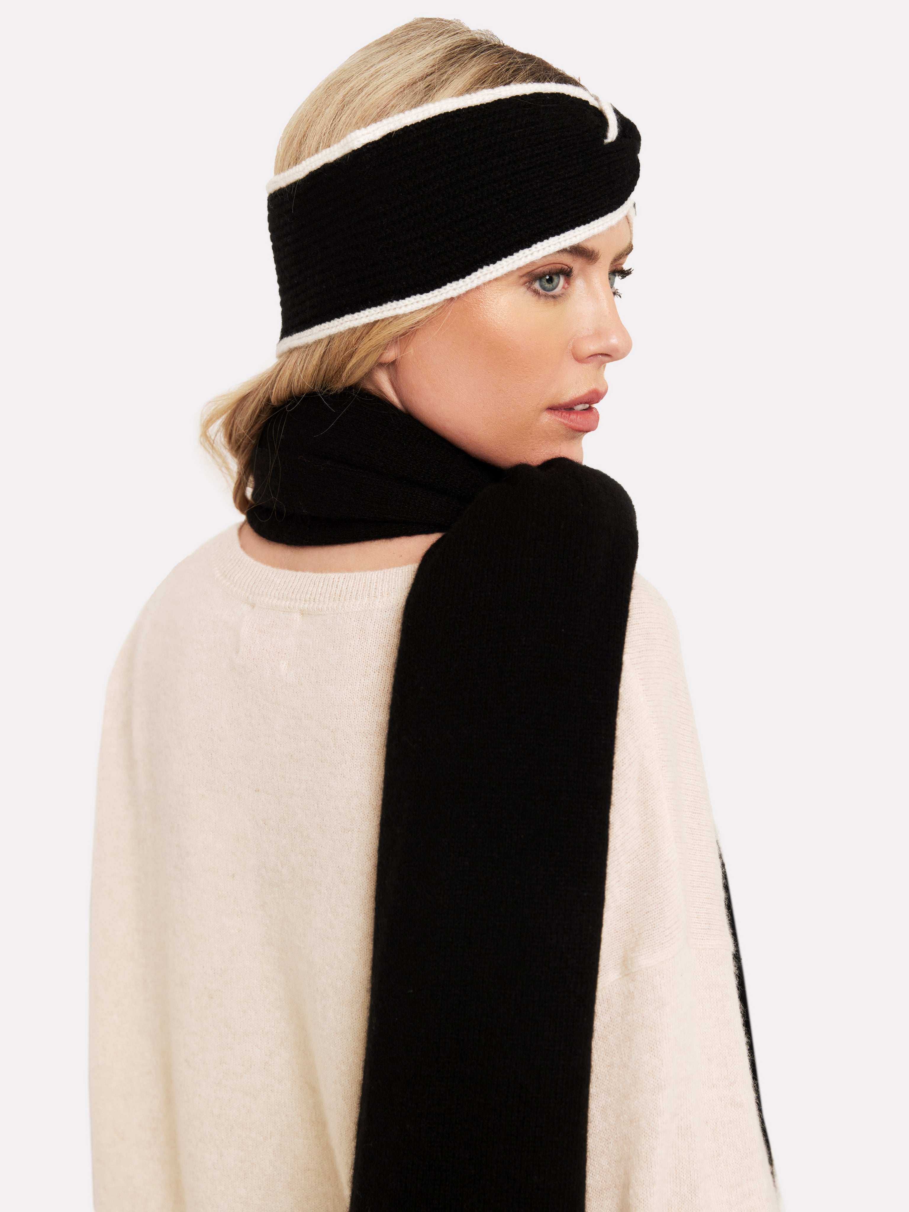 women wearing a black headband with white tipping and a black scarf