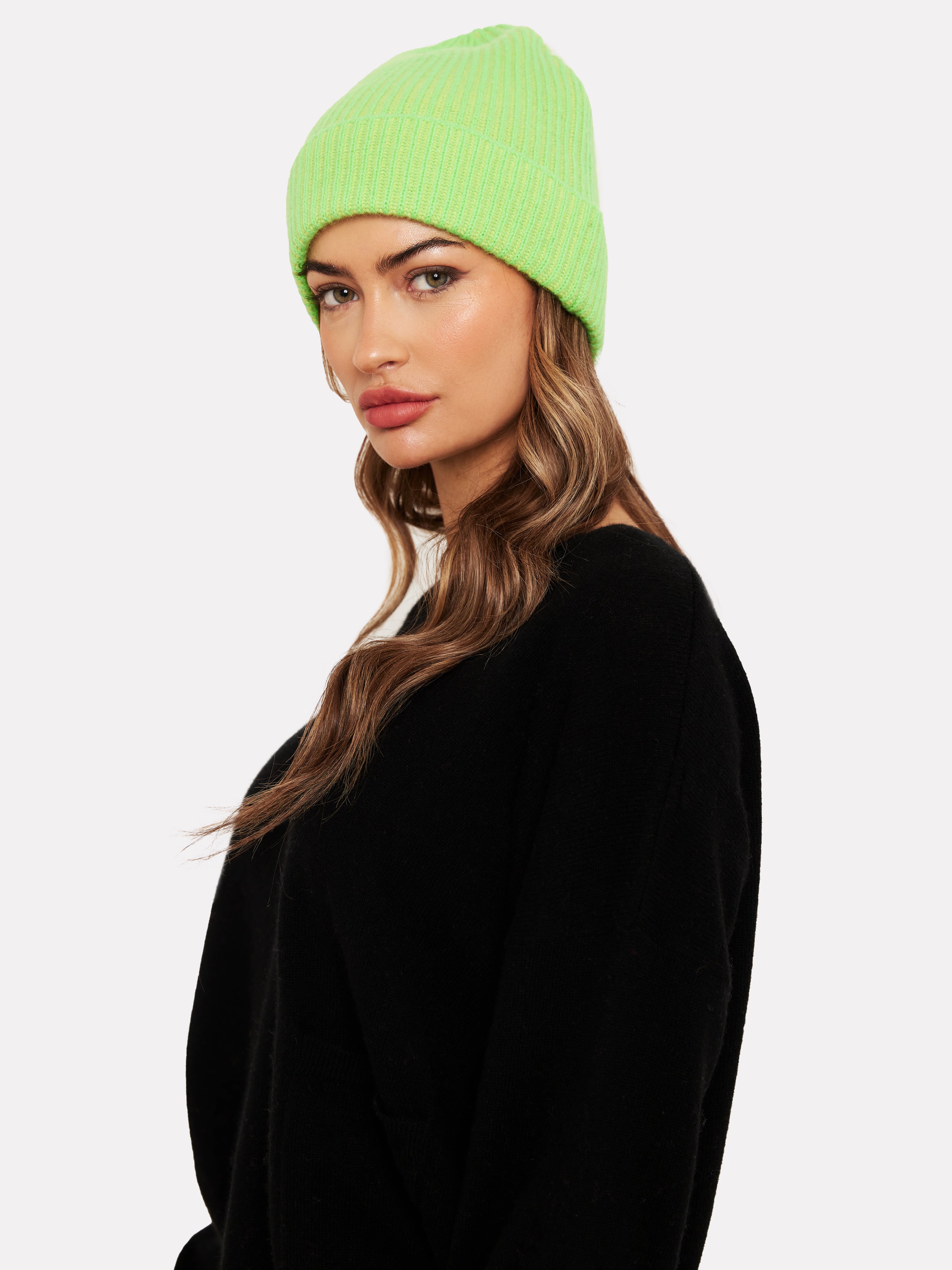Women wearing a neon green hat and black jumper