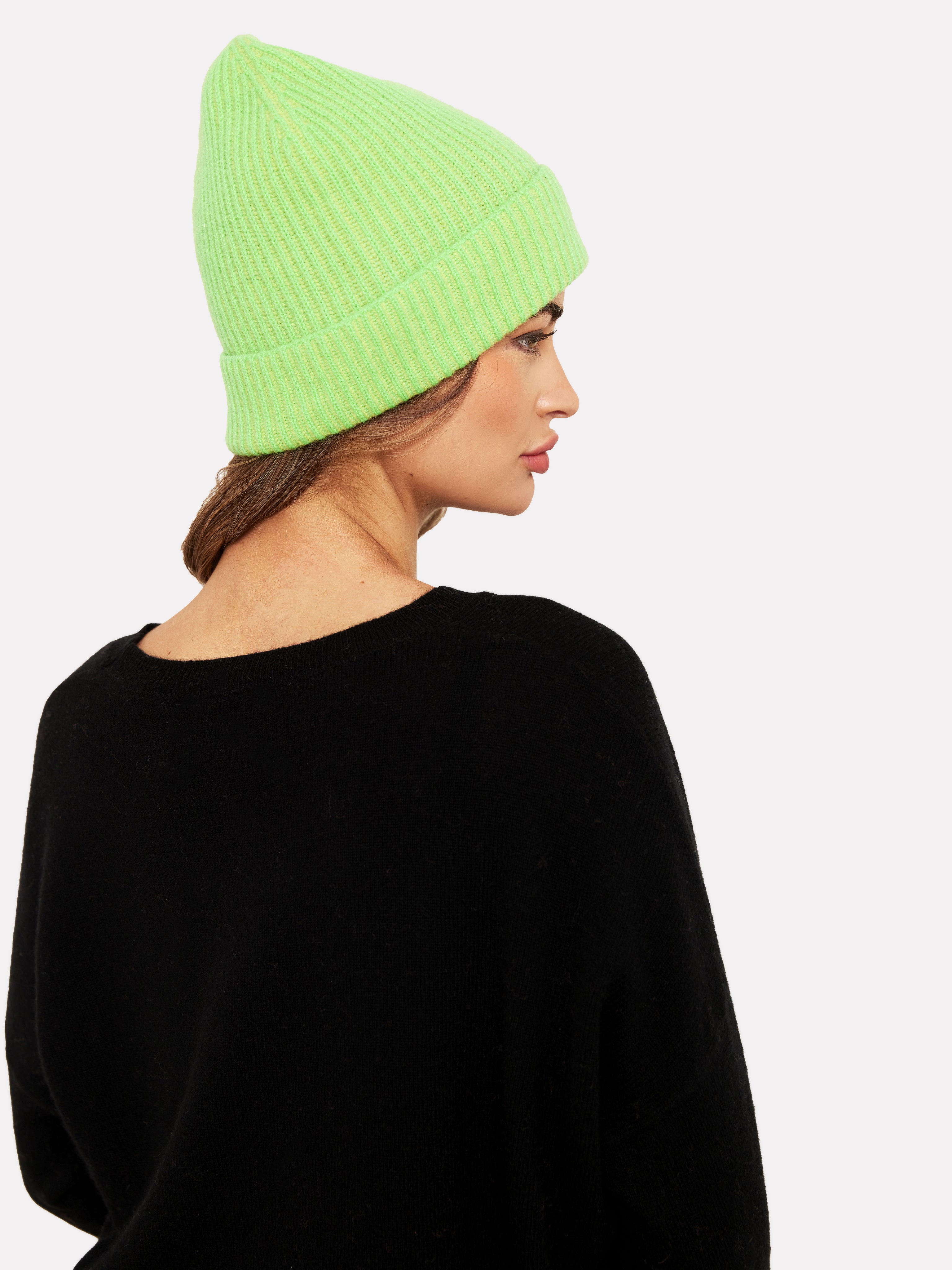 Women wearing a neon green hat and black jumper