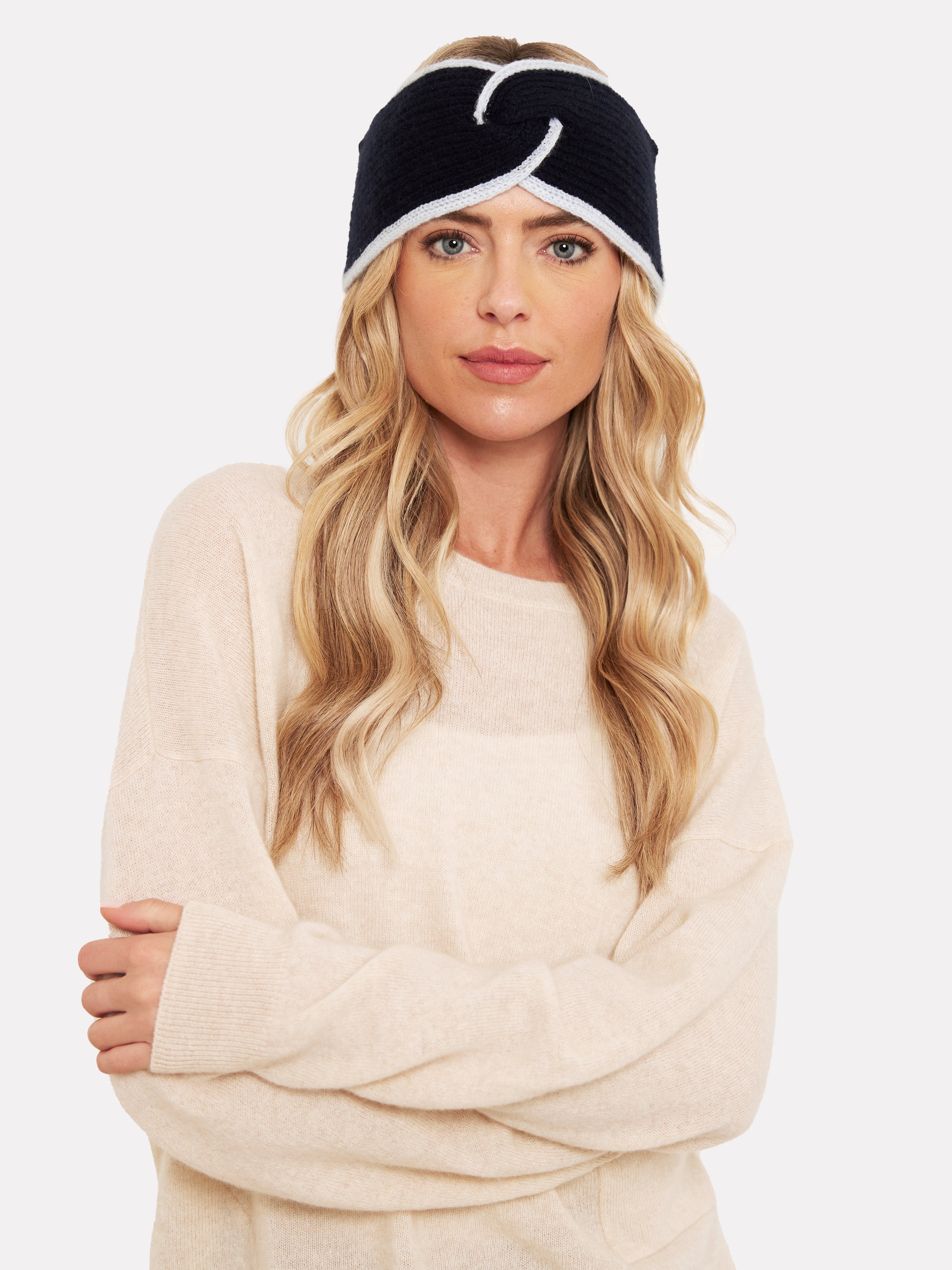 women wearing a navy blue headband with light blue tipping and beige jumper