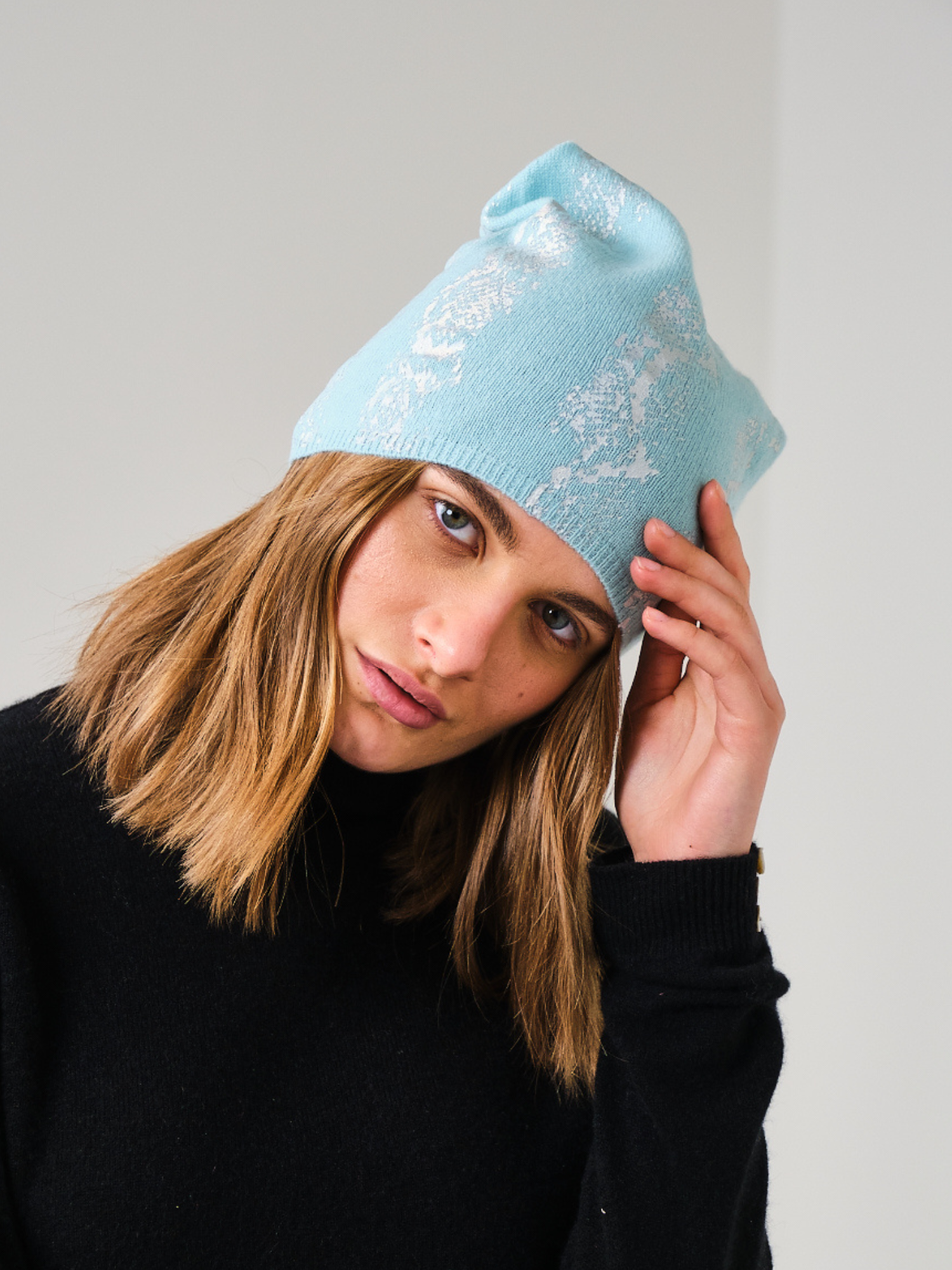 woman wearing a blue snake print hat