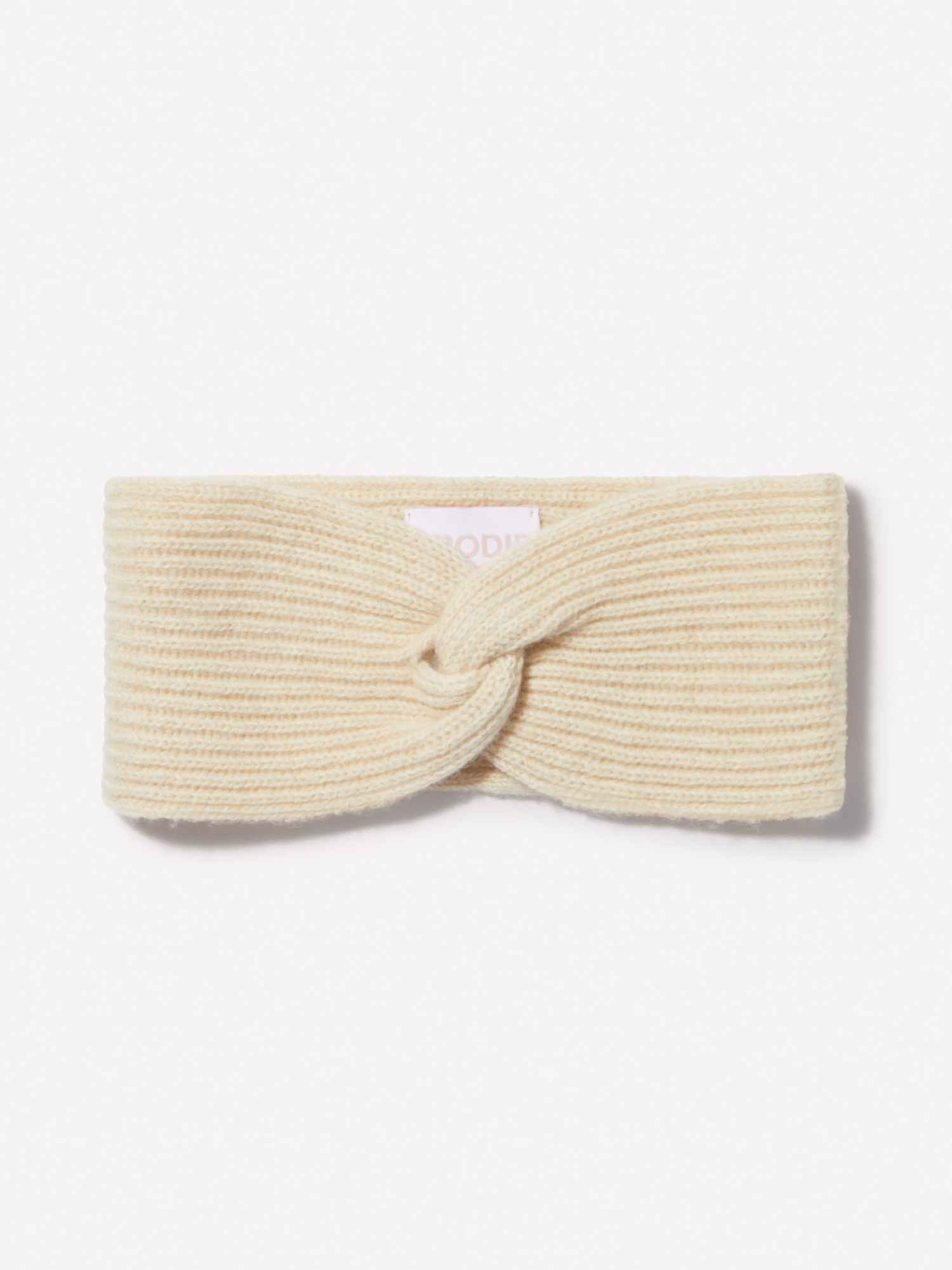 Beige knitted headband on a white background