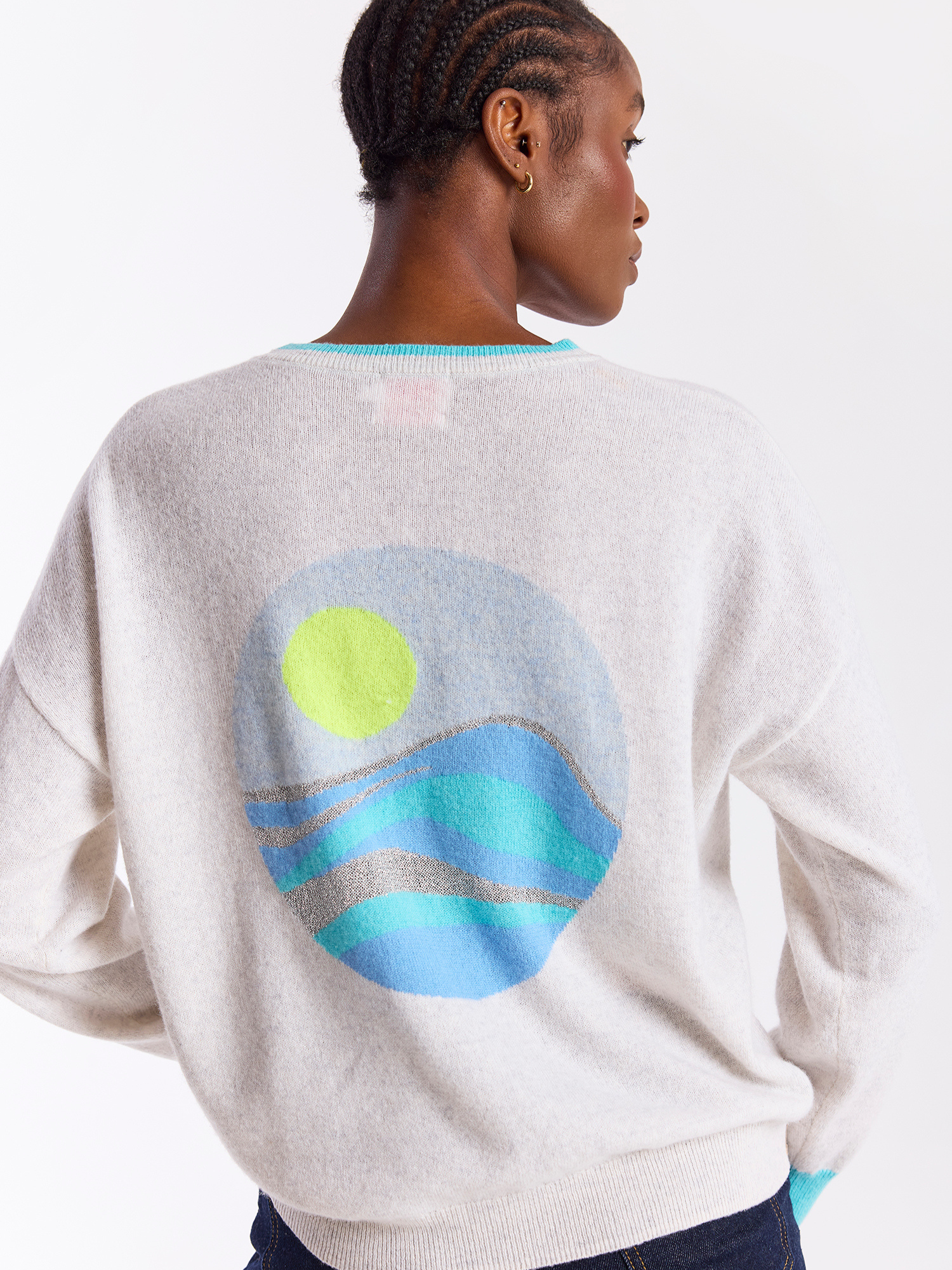 Person wearing a sweater with a colorful graphic on the back