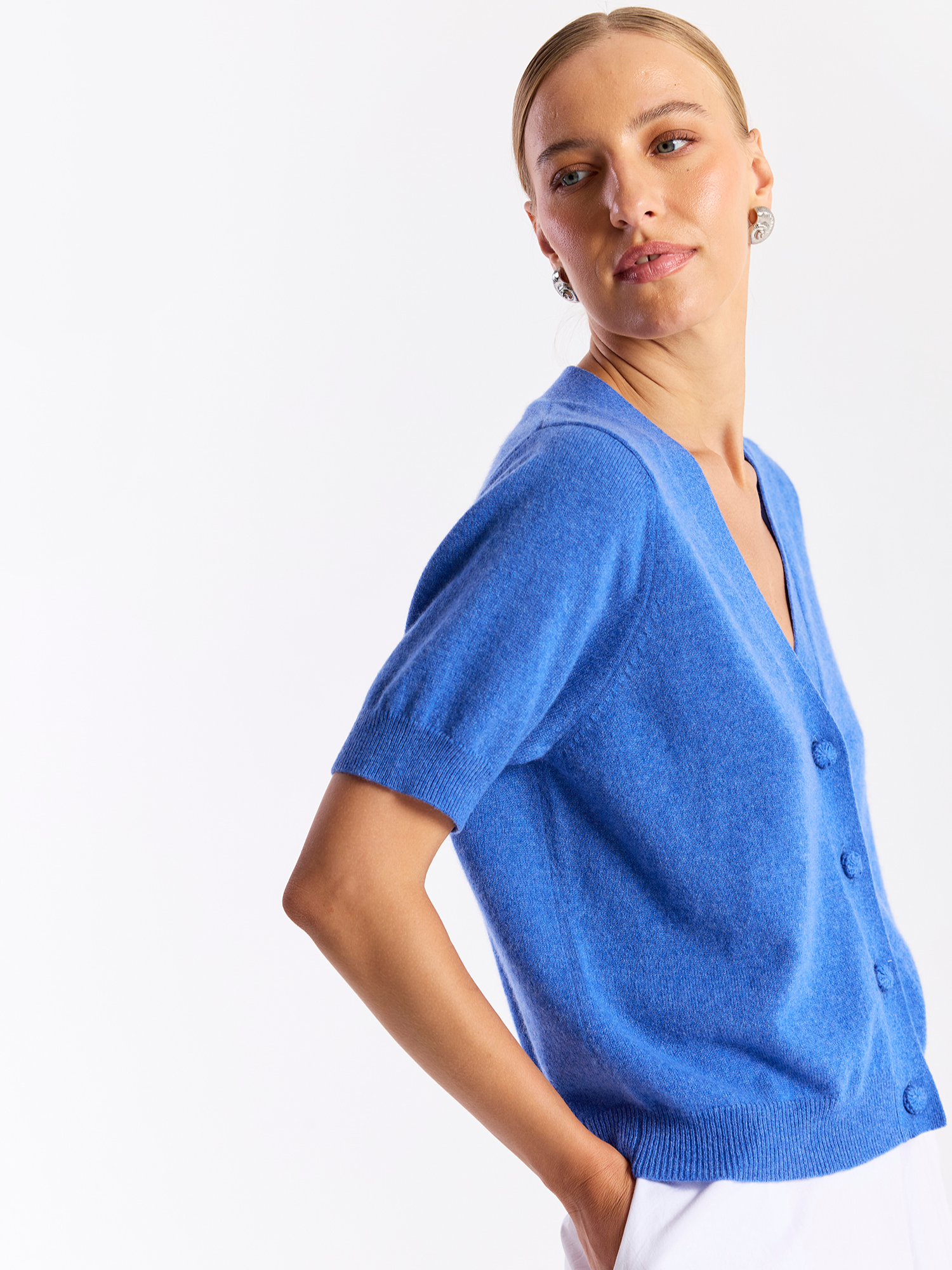 Woman wearing a blue sweater against a white background