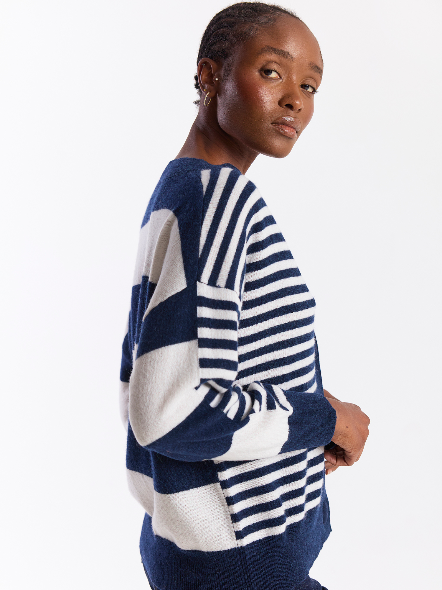 Woman wearing a blue and white striped sweater on a white background