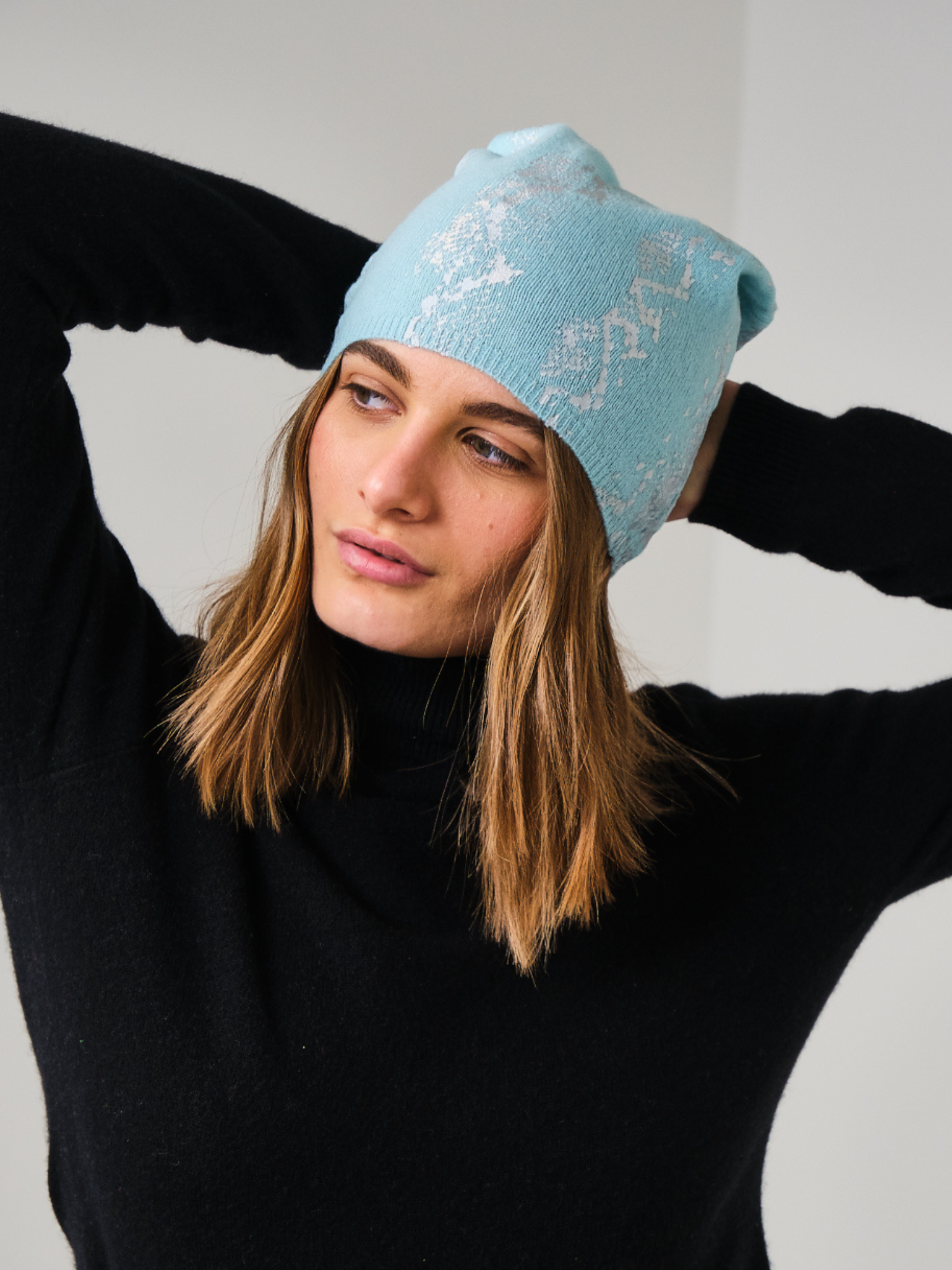 woman wearing a blue snake print hat