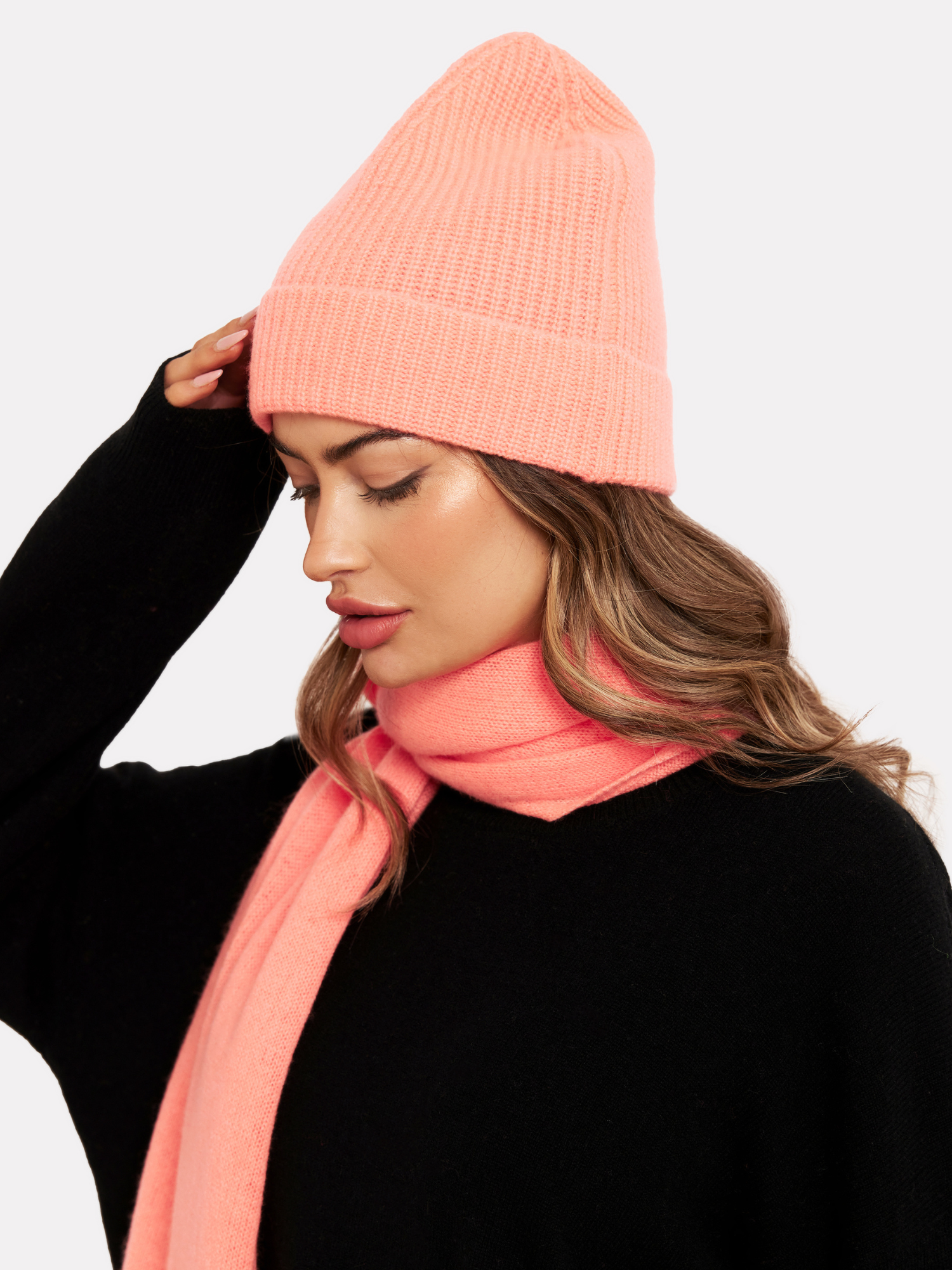woman wearing a neon coral hat and matching scarf