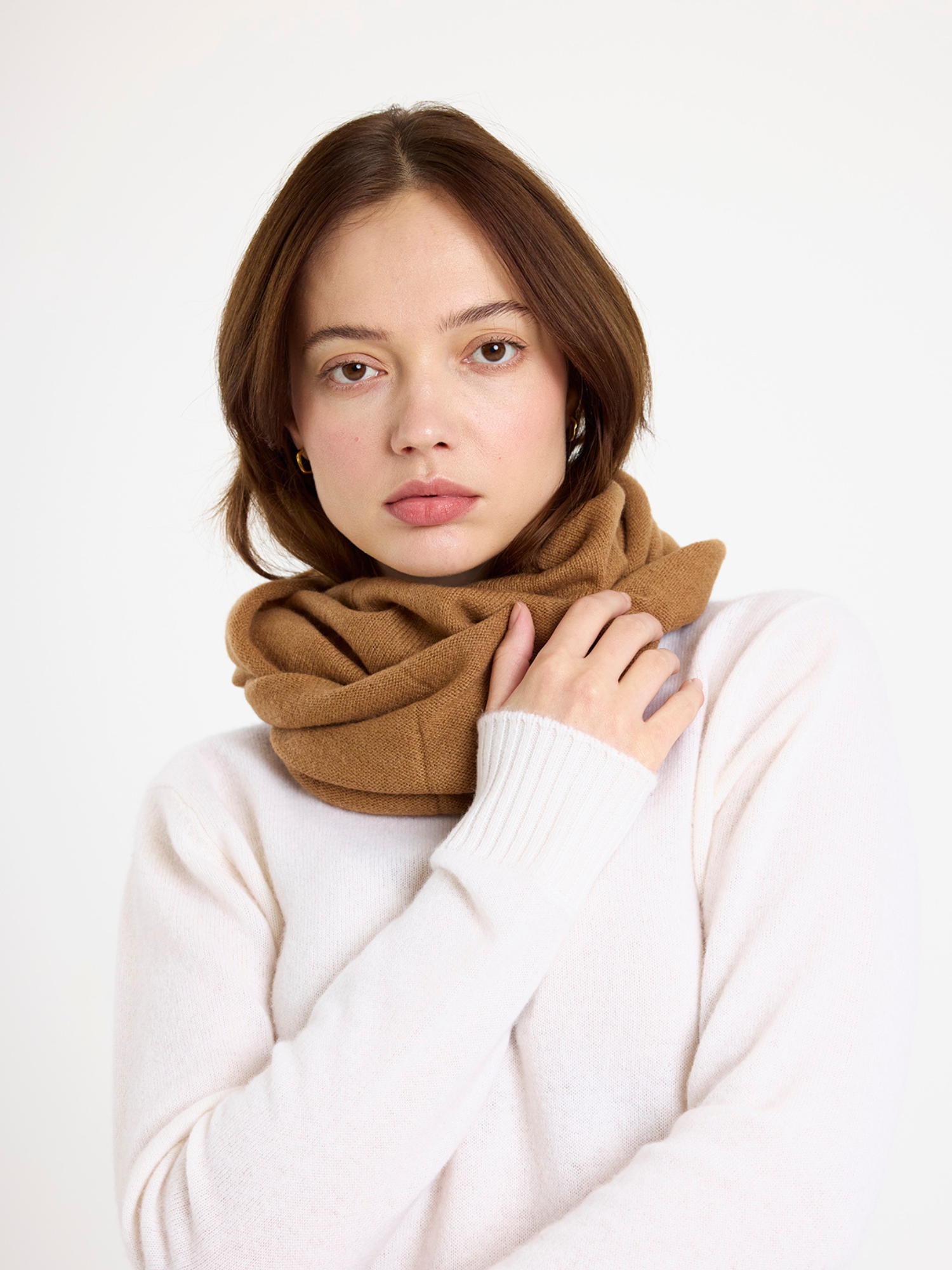 Woman wearing a brown snood against a white background