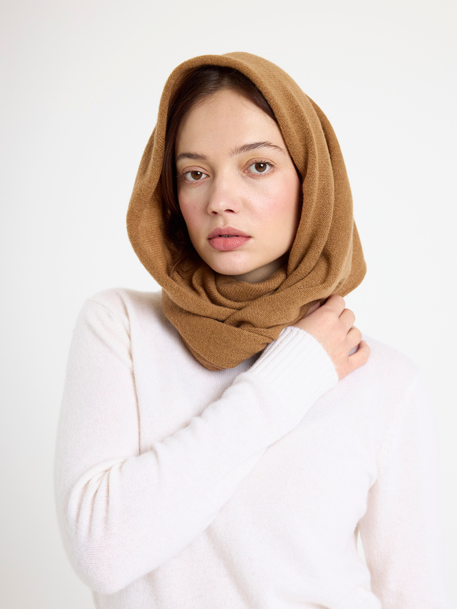 Woman wearing a brown snood against a white background
